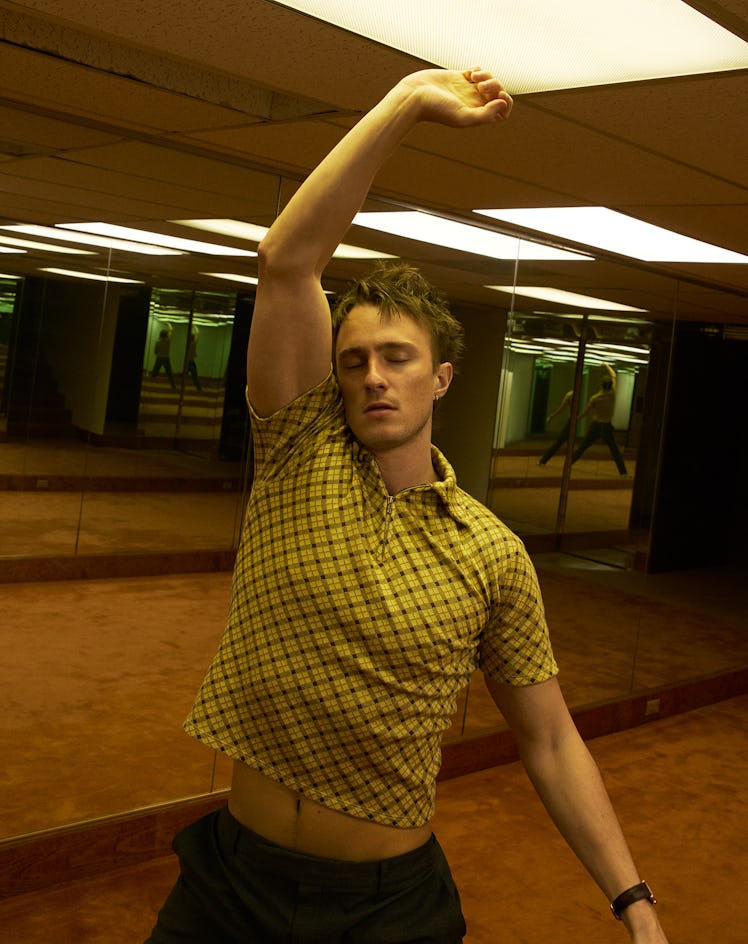 Drew Starkey wears a Miu Miu top and pants; Cartier watch; his own earring.