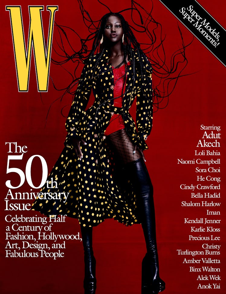 Adut Akech in a Burberry trenchcoat, corset top, fishnets, and boots on the cover of W Magazine's 50...