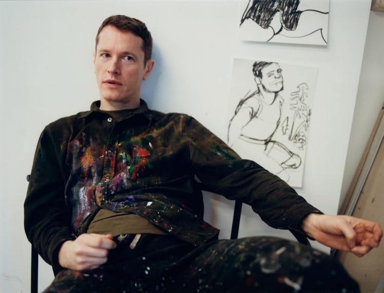 Alex Foxton sits in his studio