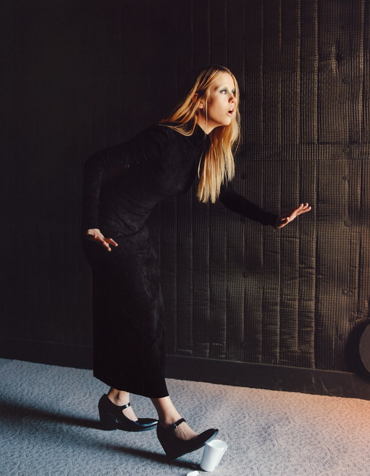 Mia Goth wears a Ferragamo dress; Prada shoes.