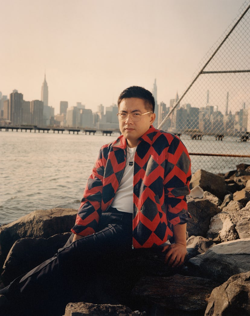 Bowen Yang wearing a Bode jacket, Sunspel T-shirt, Berluti pants, his own glasses and jewelry