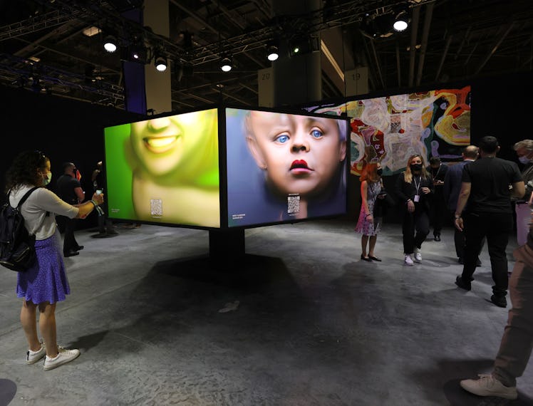 MIAMI BEACH, FLORIDA - NOVEMBER 30: Guests view an NFT art piece by German artist Mario Klingemann a...