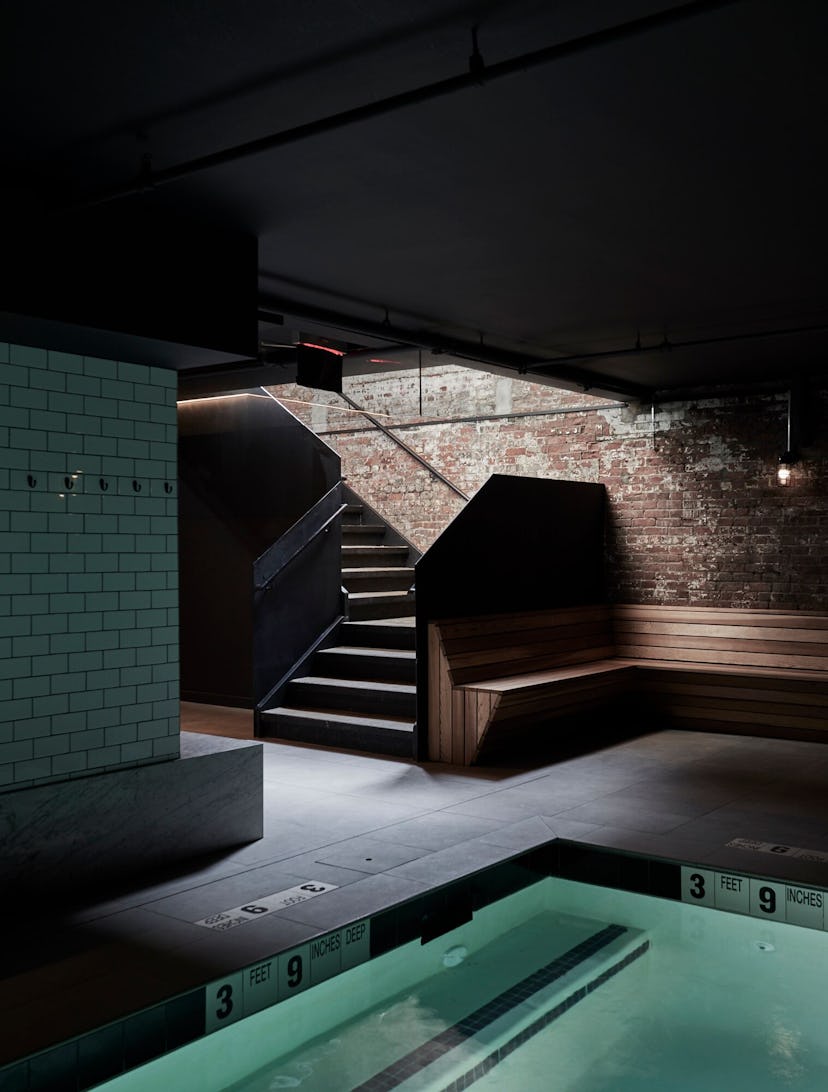  A Bathhouse in Brooklyn, an oasis-like spa, a dark room with stairs leading up, and a pool