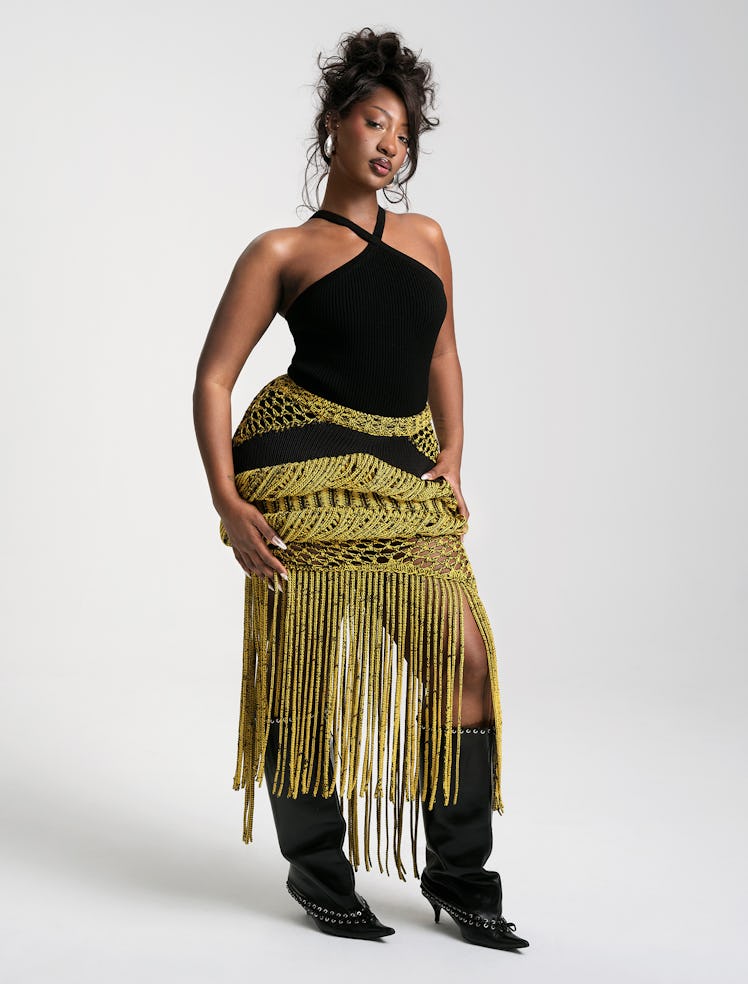 Tems wears a Michael Kors Collection top; Diotima skirt; Patricia von Musulin earrings; All-In boots...