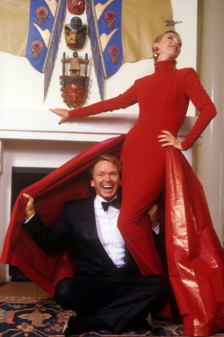 Mackie at home in 1987 with Linda Spencer, a friend and frequent house model, who poses in a red eve...