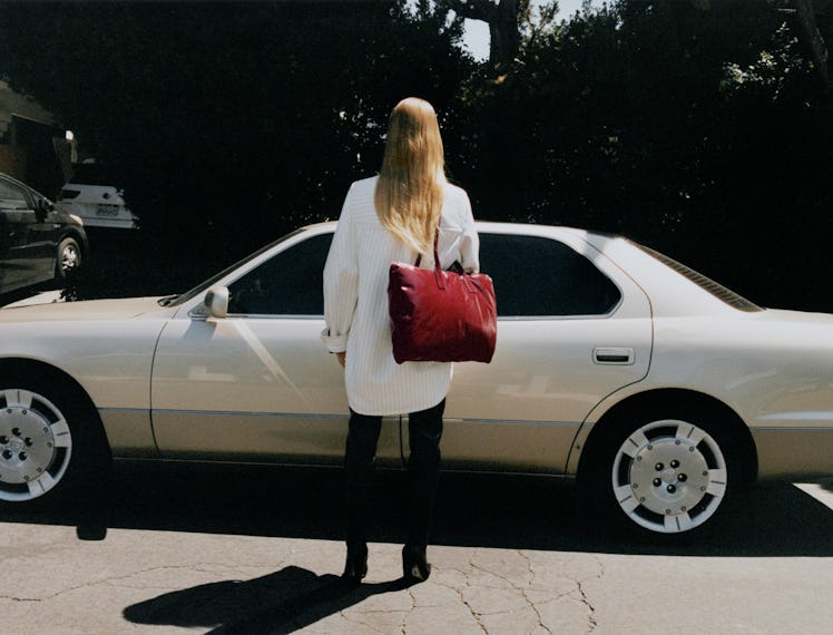 A model with a big red velvet bag